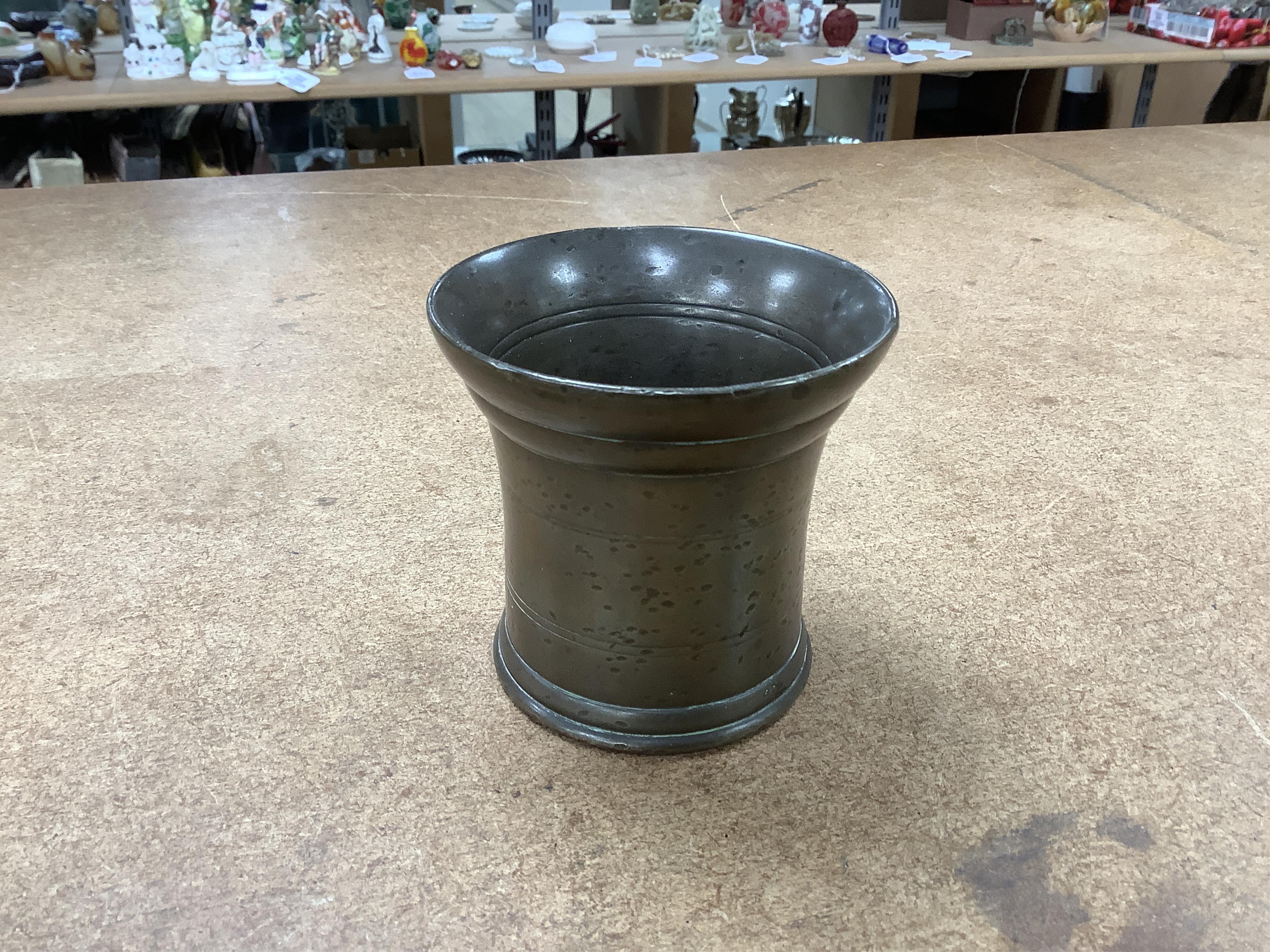 Sundry items to include a large pestle, spice grinder, flat iron on stand, bronze mortar and three other items, largest 42cm in length